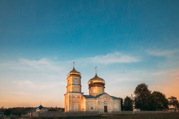 Fototapeta na wymiar Cheretyanka, Gomel Region, Belarus. Dormition Of Theotokos Church At Sunset Or Sunrise Time