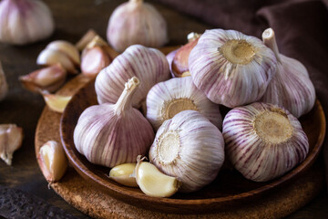 Garlic close-up. Garlic Cloves and Bulb on rustic wooden table.