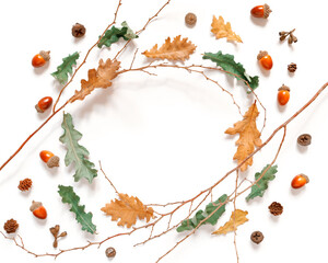 Autumn composition.The frame of twigs, dried leaves and acorns is on a white background. Autumn, fall, thanksgiving day concept. Flat lay, top view, copy space.