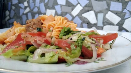 plate of Italian pasta with vegetables on the table