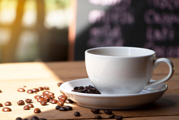 white coffee cup on a wooden table with sunlight