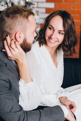 Cute young family husband and wife at the Christmas tree
