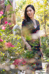 Playful and beautiful girl on warm sunny day. Woman with gorgeous smile having fun in blooming garden. Portrait of Female with dress on natural background in autumn.