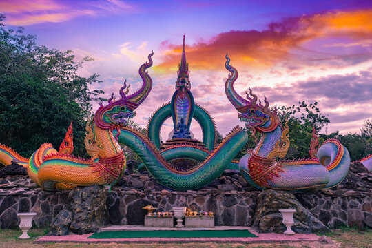 A glowing serpent statue with Twilight at Wat Pa Phupang temple Si Chiang Mai District, Ubon Ratchathani Province, Thailand.