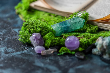 Crystalline minerals for meditation, moss, book. Magic Rock for Healing stones. Minerals for relaxation.