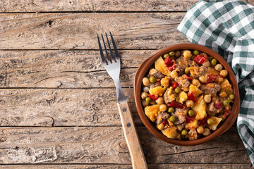 Ropa vieja food in bowl on rustic wooden table. Top view.Copy space