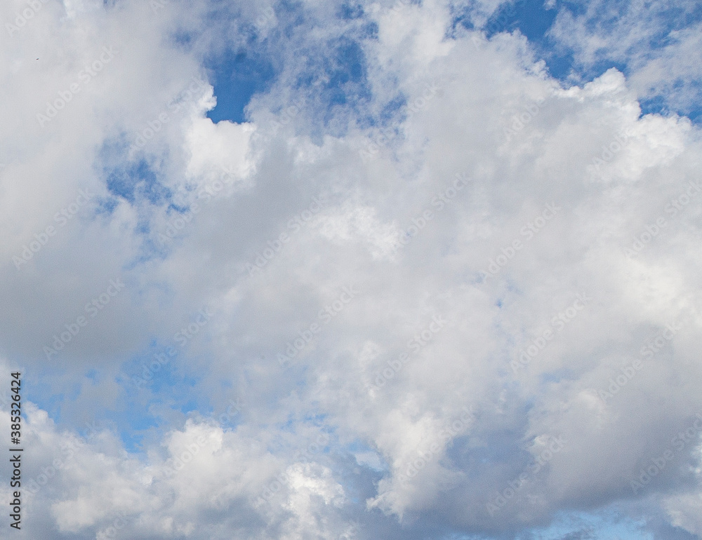 Wall mural Image of a partly cloudy and partly clear sky during the day