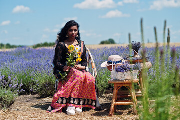 Beautiful indian girl wear saree india traditional dress in purple lavender field.