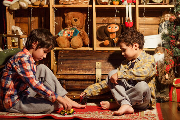 Christmas Children Open Present Gift, Happy Baby Boy looking to the gifts, Kid sitting near the Xmas Tree