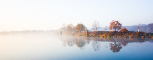 Bay on the Odra River in a misty autumn scenery.