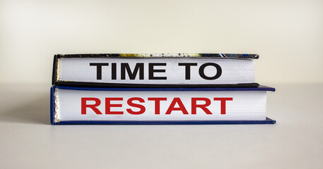 Books with text 'time to restart' on beautiful white background. Business concept, copy space.