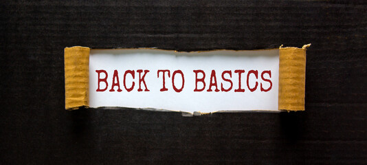 The words 'back to basics' appearing behind torn black paper. Beautiful background. Business concept.