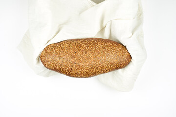 A loaf of bread on a pure white fabric blanket