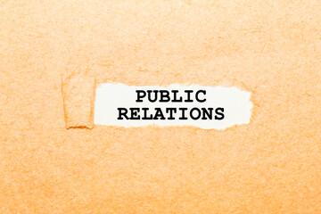 text PUBLIC RELATION on a torn piece of paper, business concept