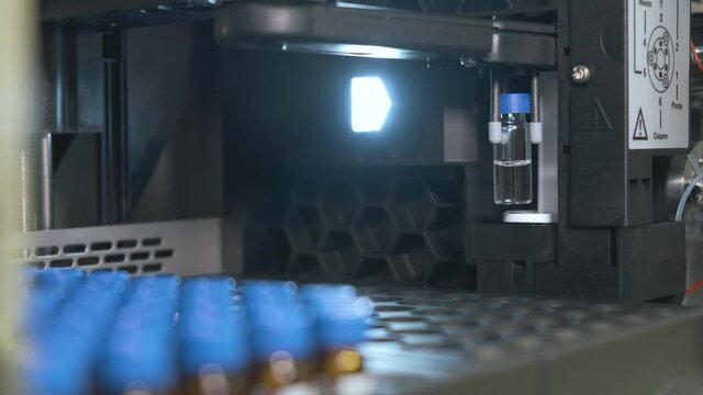 Auto sampler takes a vial and injects a sample into high performance liquid chromatography. 