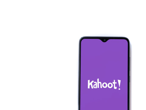 Lod, Israel - July 8, 2020: Kahoot! app launch screen with logo on the display of a black mobile smartphone isolated on white background. Top view flat lay with copy space.
