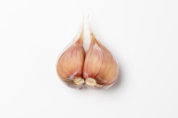 two garlic cloves on a white background