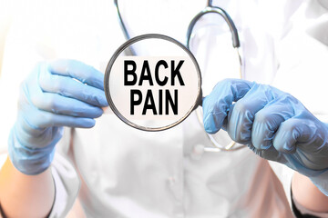 Doctor holding a card with text BACK PAIN, medical concept