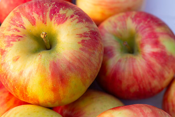 stack of apples on a white table with shallow focus