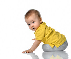 Little baby boy on floor looking over shoulder