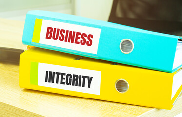 Two office folders with text BUSINESS INTEGRITY