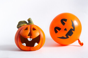 Orange decorative cheerful pumpkin lantern and balloon on a white background. Halloween, All Saints Day, a traditional fall holiday. Trick or treat. Jack lantern. Postcard.