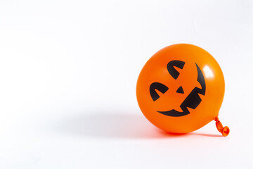 Orange decorative cheerful pumpkin balloon on a white background. Halloween, All Saints Day, a traditional fall holiday. Trick or treat. Jack lantern. Postcard. Copy space.