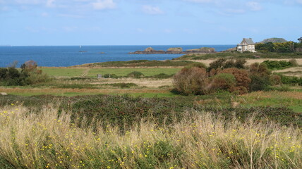 Paysage de lande au bord de la mer à Rothéneuf, à Saint-Malo en Bretagne, avec une maison...