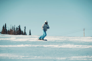 Active man snowboarder riding on slope. Snowboarding closeup. Sheregesh ski resort