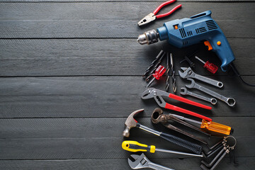 Working tools on black wooden background.