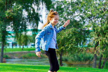 girl runs through a city park, bright summer day