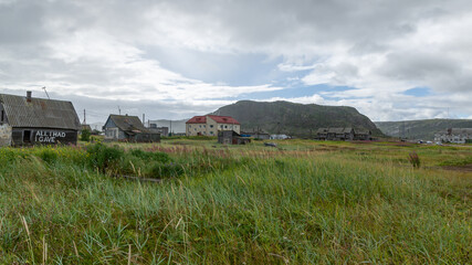 Fototapeta na wymiar Houses in the village of Teriberka on the Barents sea coast, Russia, August 2020
