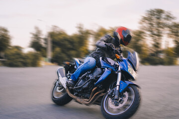biker on a motorcycle rides on asphalt