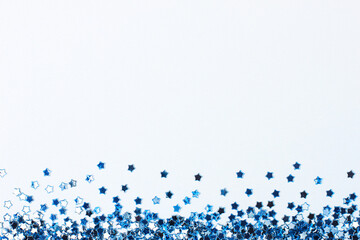 Blue confetti on white. Colorful Christmas or holiday background