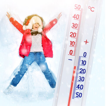 Real winter concept with a girl making snow angel in a snow and big thermometer. Еhermometer shows frosty temperature. Christmas holidays and entertainment background. Square orientation.