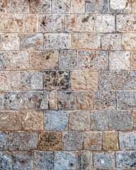 regular cut stone wall closeup, natural textured background