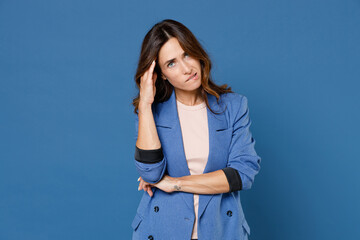 Puzzled preoccupied pensive concerned young brunette woman 20s wearing basic jacket standing put...