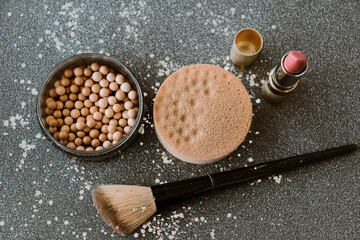 Face powder pearls and pink lipstick