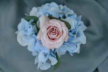 Beautiful close-up picture of soft pastel pink and blue roses on grey background. Wedding flowers decoration for wedding day or other celebration.