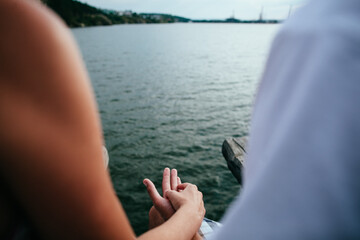 man and woman holding each other's hands, close-up, in nature, outdoors, hugs, tenderness