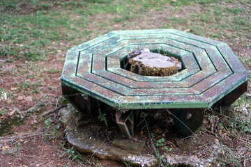 An old bench made of metal in a park
