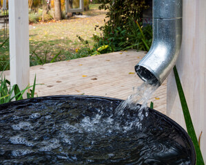 Water drains from the drain pipe into a metal container