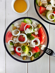 Fresh salad of tomatoes, cucumbers, peppers, olives and cheese, seasoned with olive oil