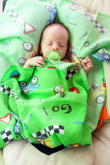 newborn baby child sleeping with green pacifier
