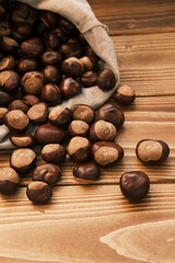 Close up shot of chestnut in the linen bag on a wooden table 