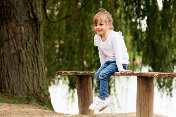 little girl sitting on bench