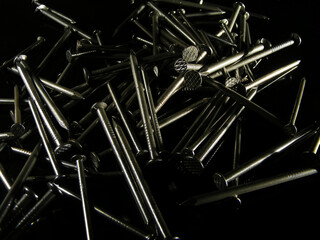 Steel nails on black background. construction concept
