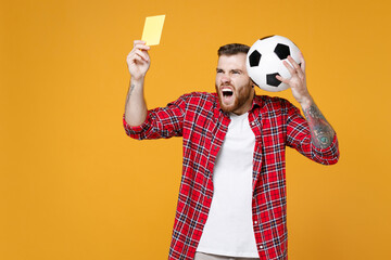 Irritated man football fan in red shirt cheer up support favorite team with soccer ball propose...