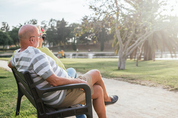 pensioners couple sitting on a park