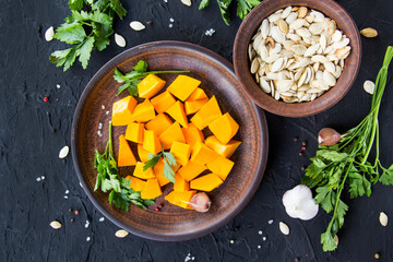 Beautifully chopped pumpkin salad, herbs, and ingredients for the dish. Creative atmospheric decoration